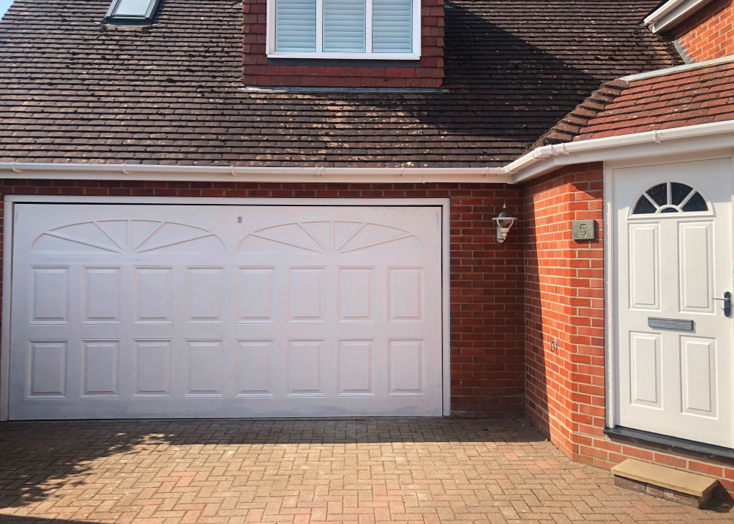 A white up and over garage door and new front door to match.
