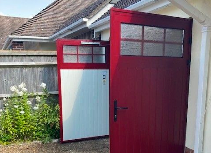 A red side-hinged garage door.