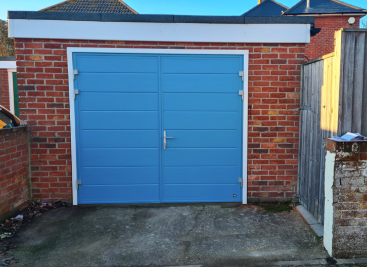 Newly fitted side hinged blue garage doors.