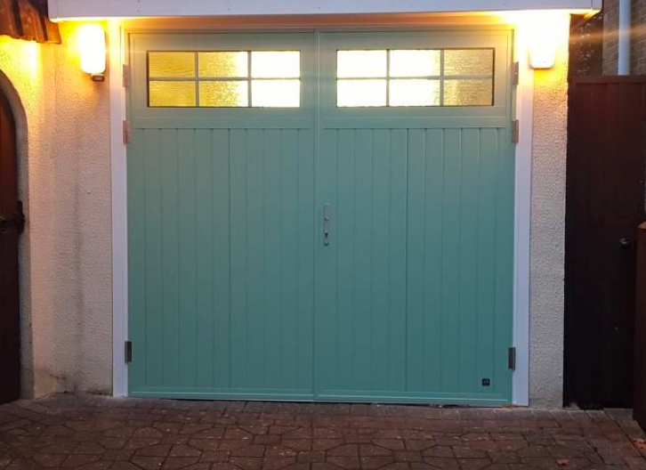 A green side-hinged garage door.