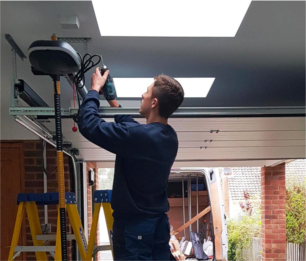 An engineer adding an automation system to a roller garage door.