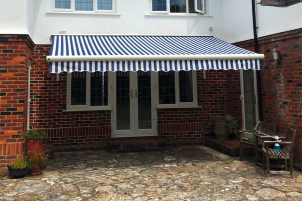 Photo of an awning fitted to a house over the back garden.