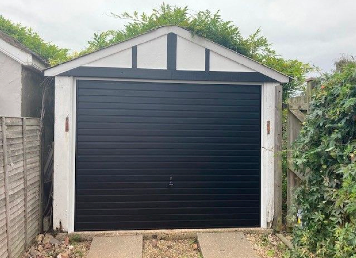 A black sectional garage door.