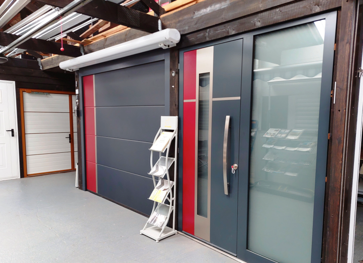 Example sectional garage doors and front doors in a showroom.