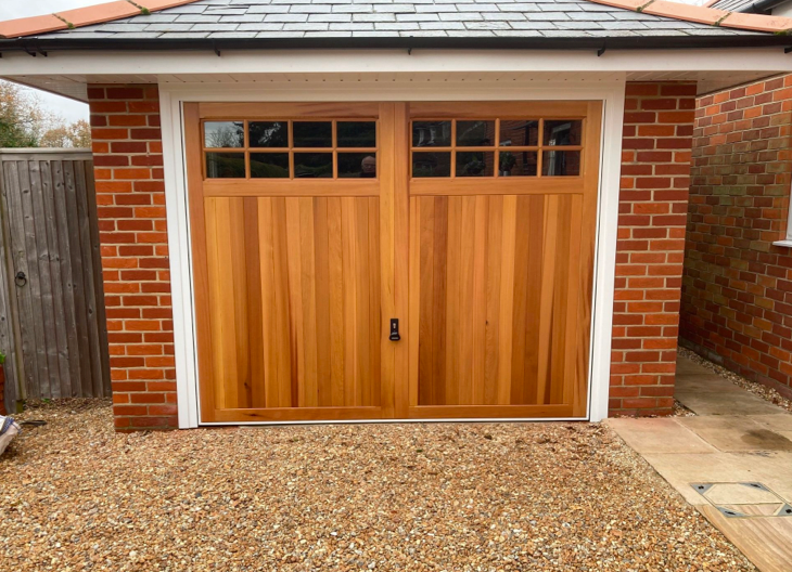 A wooden side-hinged garage door.