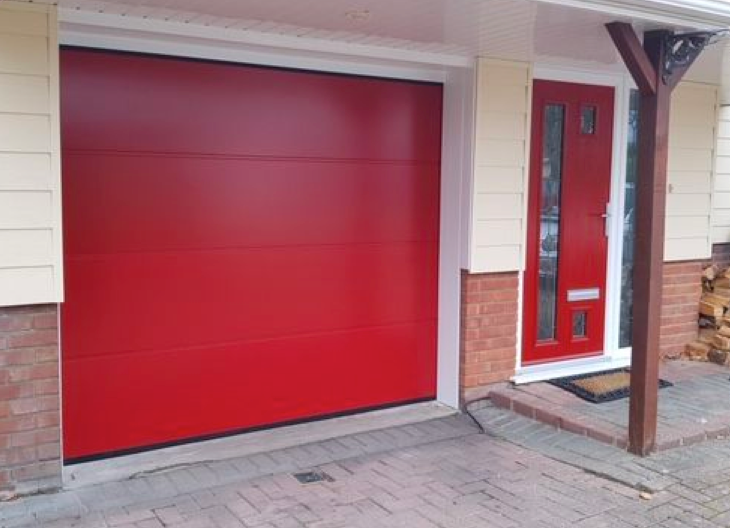 A new red sectional garage door and front door.