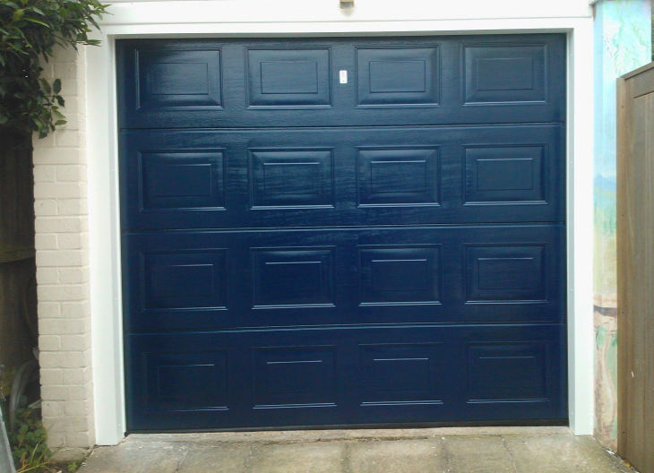 A dark blue sectional garage door.