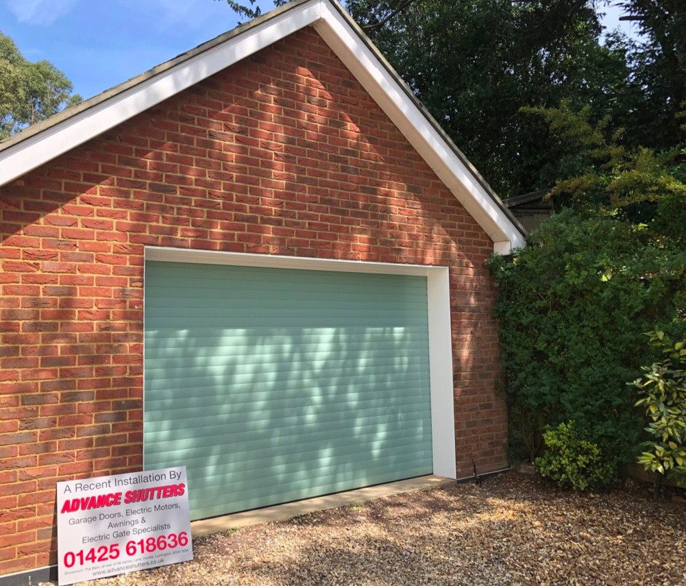 Photo of a teal roller shutter garage door, fitted in Christchurch.