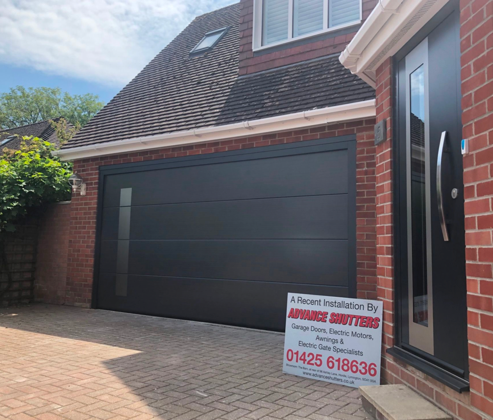 A new fitted black sectional garage door.