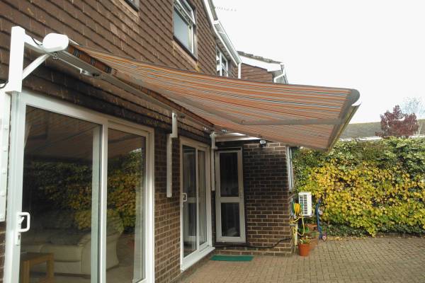 Photo of an awning attached to a house and extended out.